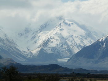 Scenic view of mountains against cloudy sky