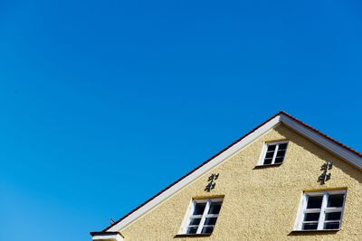 Low angle view of building against clear blue sky