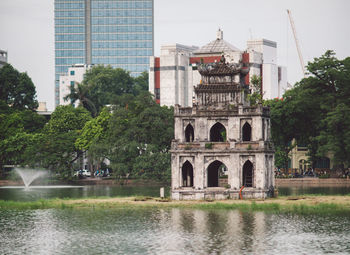 View of buildings by lake