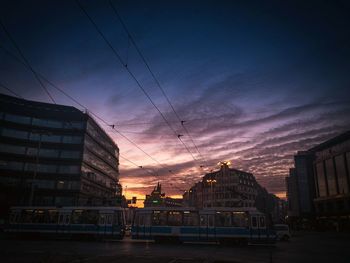 Buildings in city at sunset