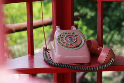 Close-up of telephone booth on table