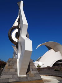 Low angle view of white building against blue sky