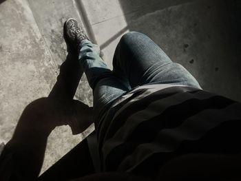 Low section of man relaxing on floor