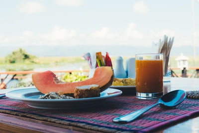 Breakfast served with some fruit and juice