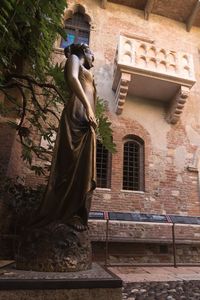 Low angle view of statue against building