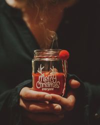 Close-up of hand holding glass jar