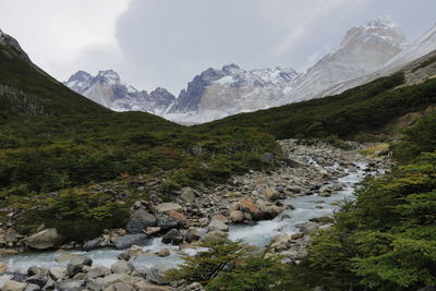 Scenic view of mountains against cloudy sky