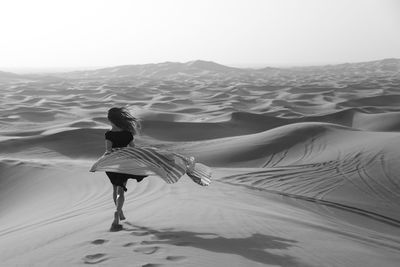 Full length of man on sand dune