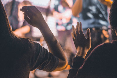 Rear view of people dancing at music concert