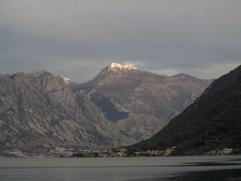 Scenic view of lake and mountains against sky