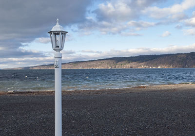 View of calm beach against sky