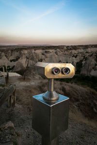 Close-up of coin-operated binoculars against sky