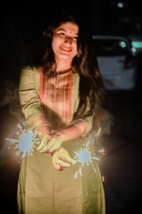 Woman smiling at night