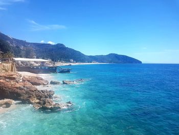 Scenic view of sea against blue sky