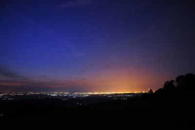 Scenic view of silhouette illuminated against sky at night