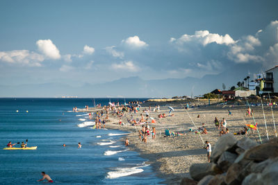 People on beach against sky