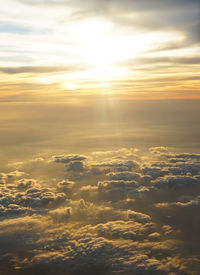 Aerial view of clouds over landscape during sunset