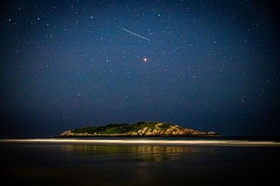 Scenic view of sea against sky at night