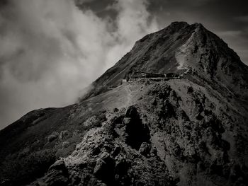 Low angle view of snowcapped mountain against sky