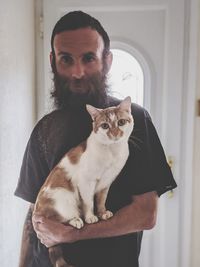 Portrait of cat sitting with its owner