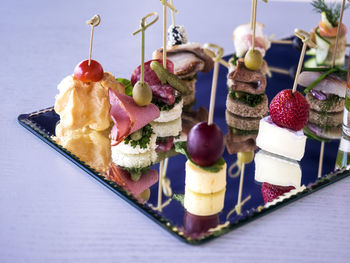 Close-up of various canapes and snacks served on table