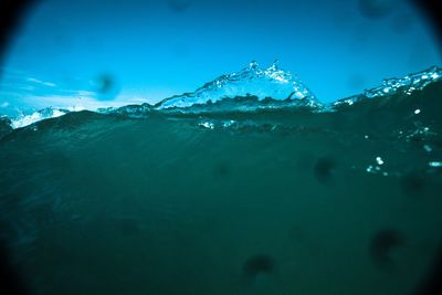 Close-up of frozen sea against blue sky