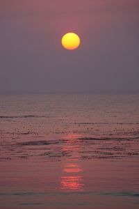 Scenic view of sea against orange sky