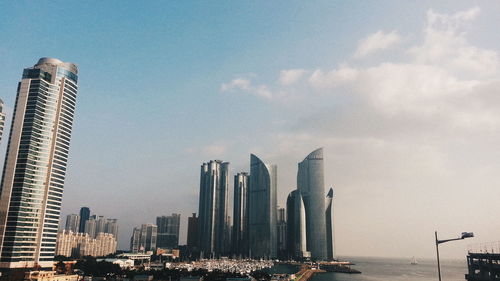 View of skyscrapers against cloudy sky