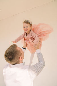 High angle view of cute girl playing with arms raised