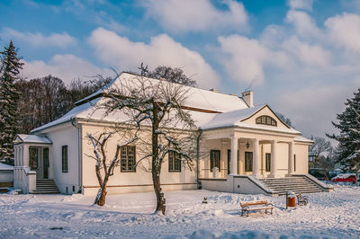 Houses and buildings against sky during winter