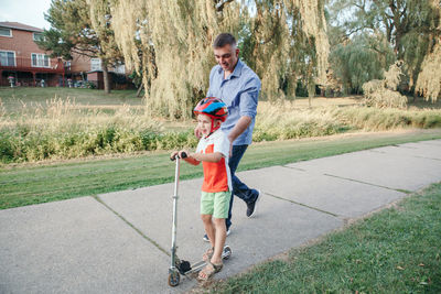 Full length of boy holding while standing on grass