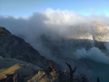 Smoke emitting from volcanic mountain against sky