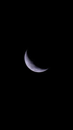 Low angle view of half moon against sky at night