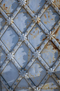 Decorative wrought iron elements on antique doors close-up