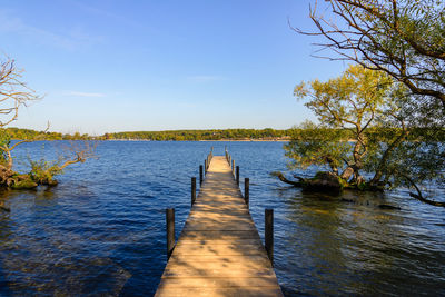 View from long wooden pier onto wannsee lake and havel river in autumn in berlin, germany.