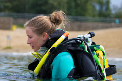 Woman with diving equipment at beach