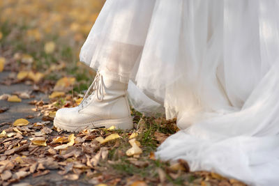 Low section of bride standing on field