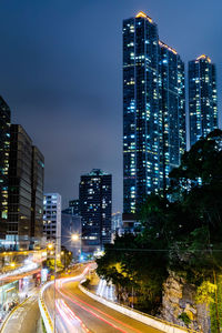 Illuminated buildings in city against sky at night