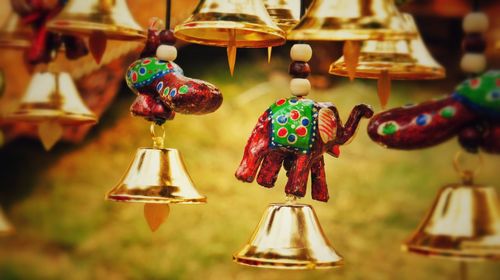 Close-up of animal decorated bells at flea market in surajkund mela