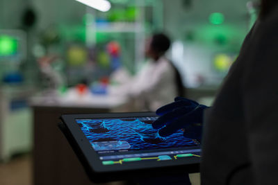 Rear view of man using laptop on table