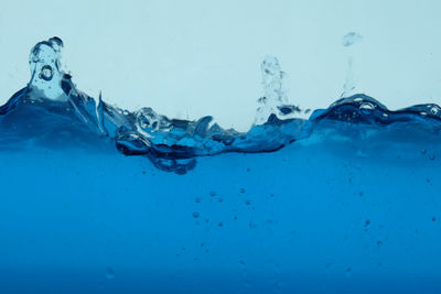 Close-up of water splashing on blue sea