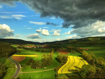 Scenic view of agricultural field against sky