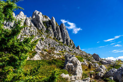 Low angle view of rock formations against sky