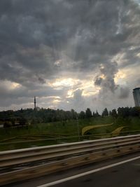 Road by street against sky in city