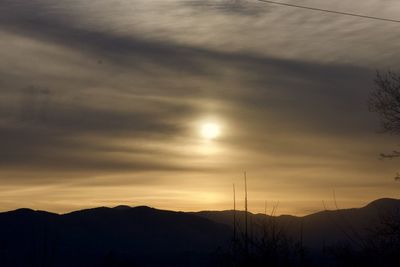 Scenic view of silhouette mountains against sky at sunset