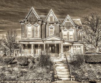 Exterior of abandoned house against sky