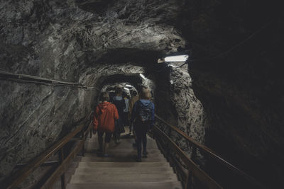 Rear view of men in tunnel