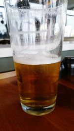 Close-up of beer glass on table