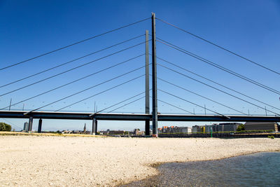 View of suspension bridge against clear blue sky