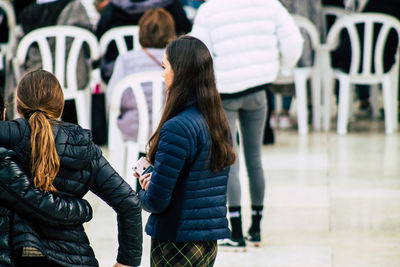 Rear view of people standing outdoors